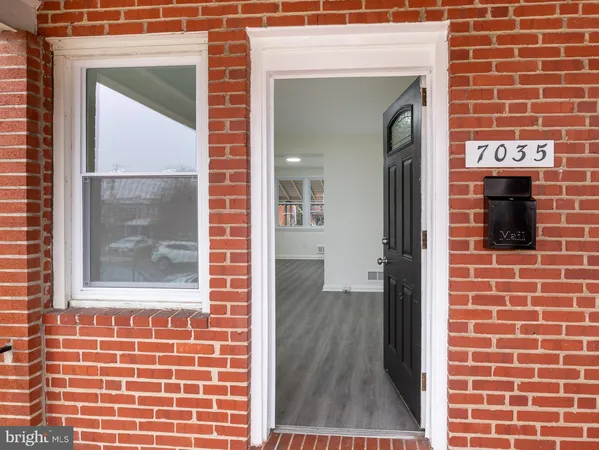 a view of front door of house with wooden floor