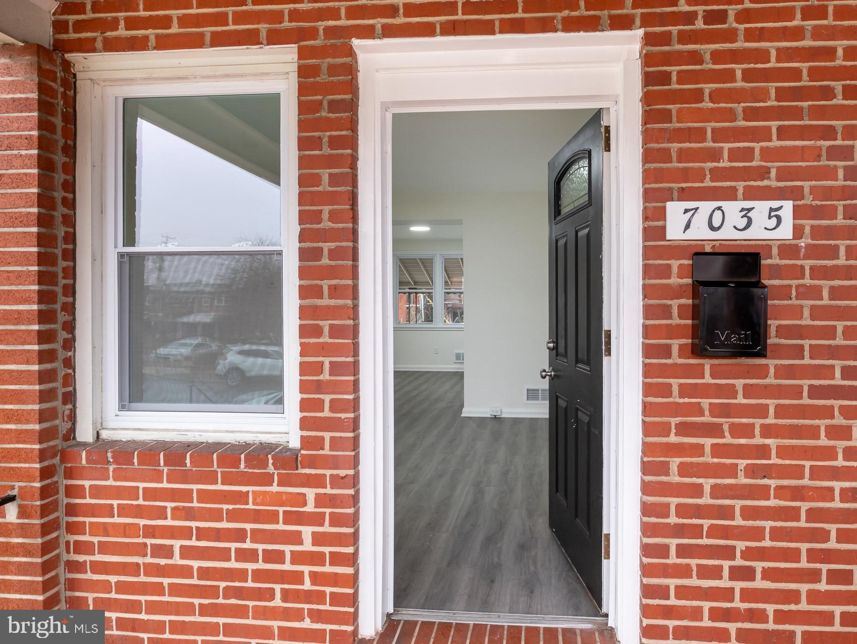 7035 Gough Street Baltimore, MD 21224 - Photo 2 of 25 a view of front door of house with wooden floor