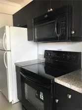 a close view of a stove a microwave and cabinets