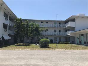 1150 East Sample Road, Unit 306 Pompano Beach, FL 33064 - Photo 9 of 9 a front view of a house with a yard
