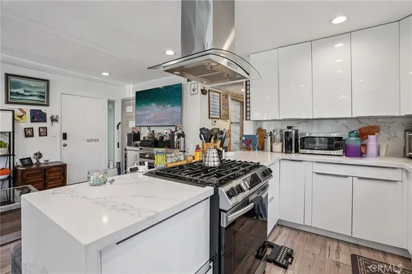 a kitchen with stainless steel appliances a stove a sink a refrigerator and cabinets