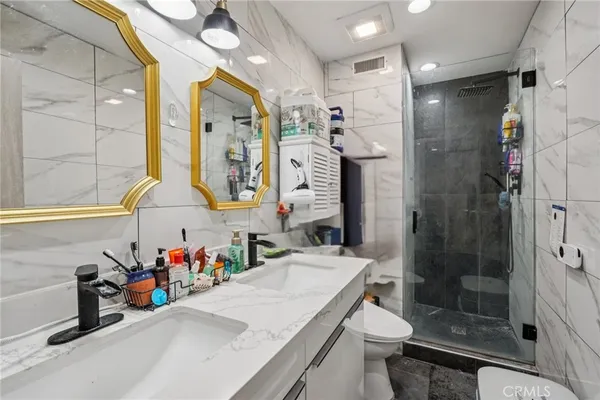 a bathroom with a sink vanity mirror and toilet