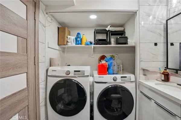 a utility room with sink dryer and washer