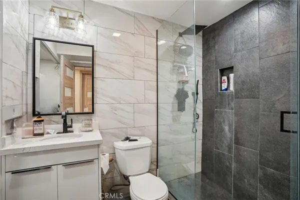 a bathroom with a sink toilet and shower
