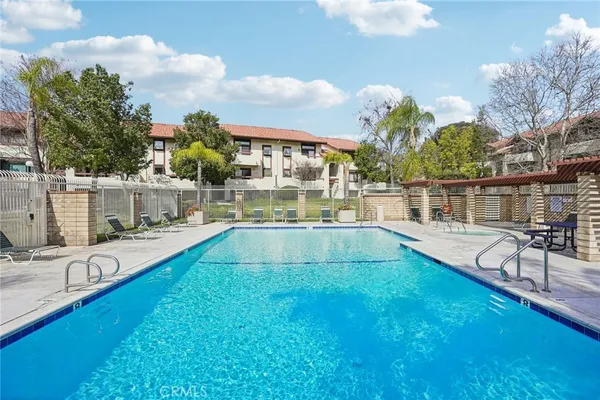 a view of a house with swimming pool and sitting area