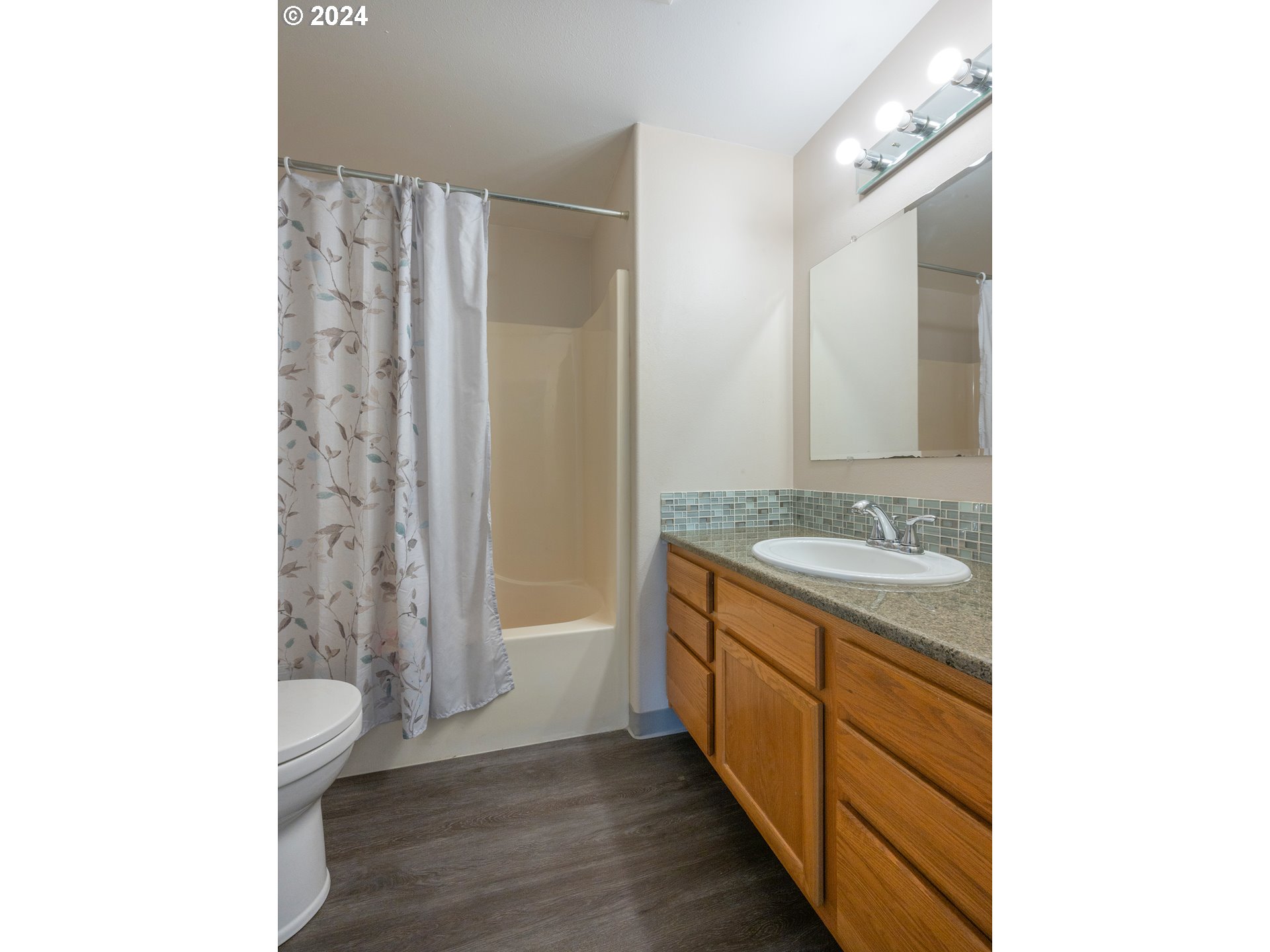 889 Aldridge Place Springfield, OR 97478 - Photo 13 of 46 a bathroom with a granite countertop sink a toilet and shower