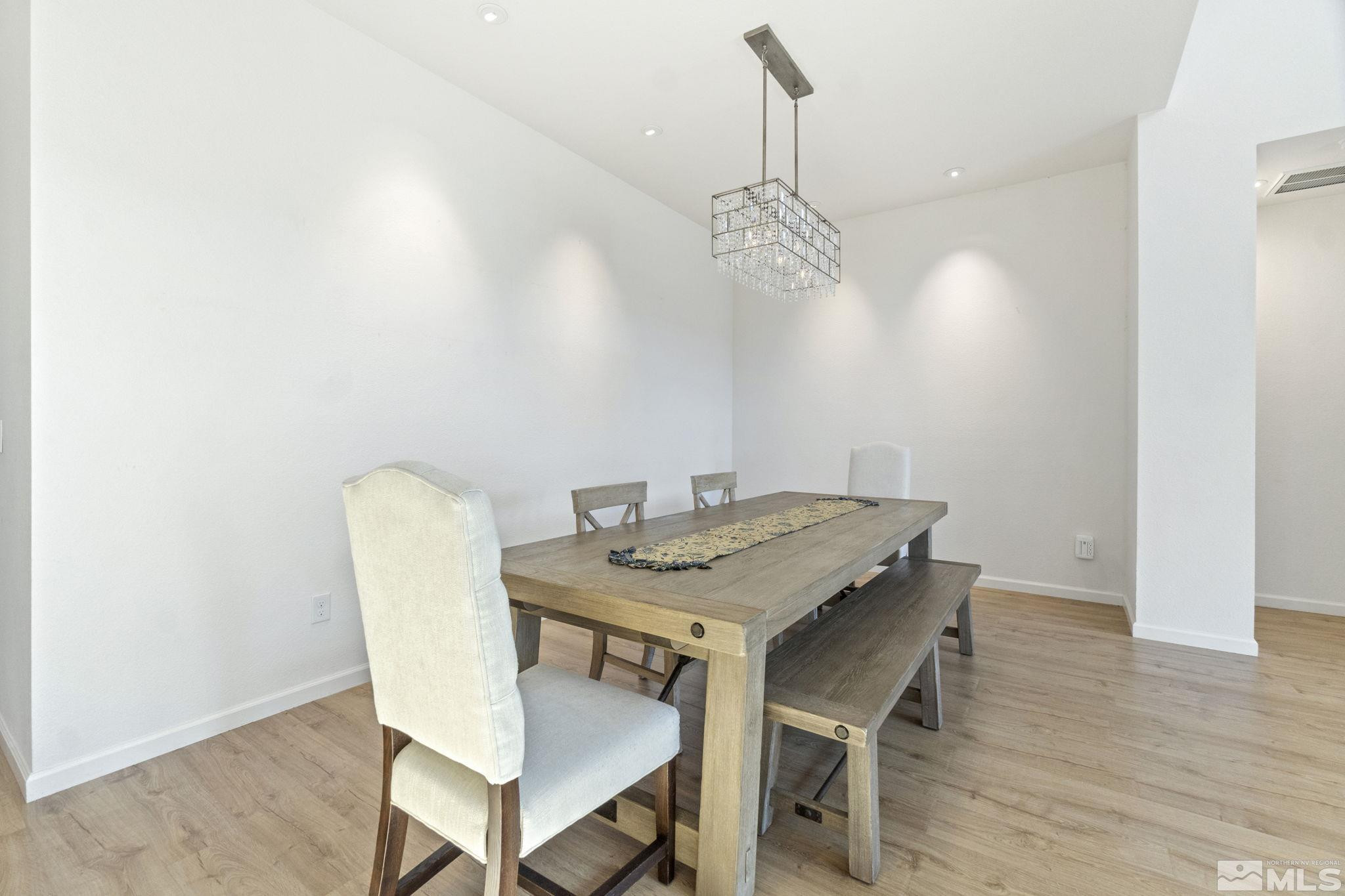 9401 Flying Horse Road Reno, NV 89521 - Photo 17 of 40 a view of a dining room with furniture and wooden floor