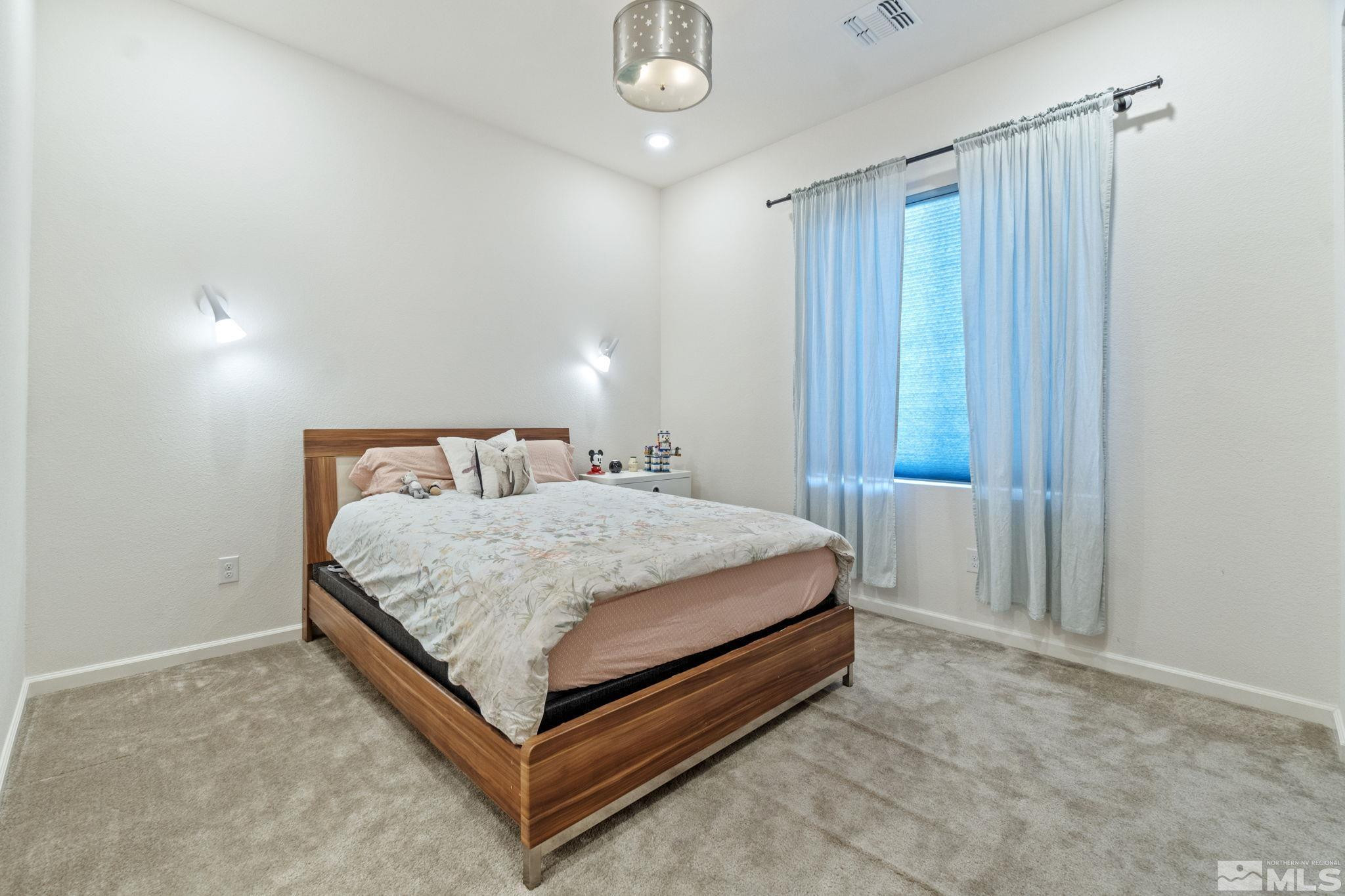 9401 Flying Horse Road Reno, NV 89521 - Photo 28 of 40 a bedroom with a bed and window
