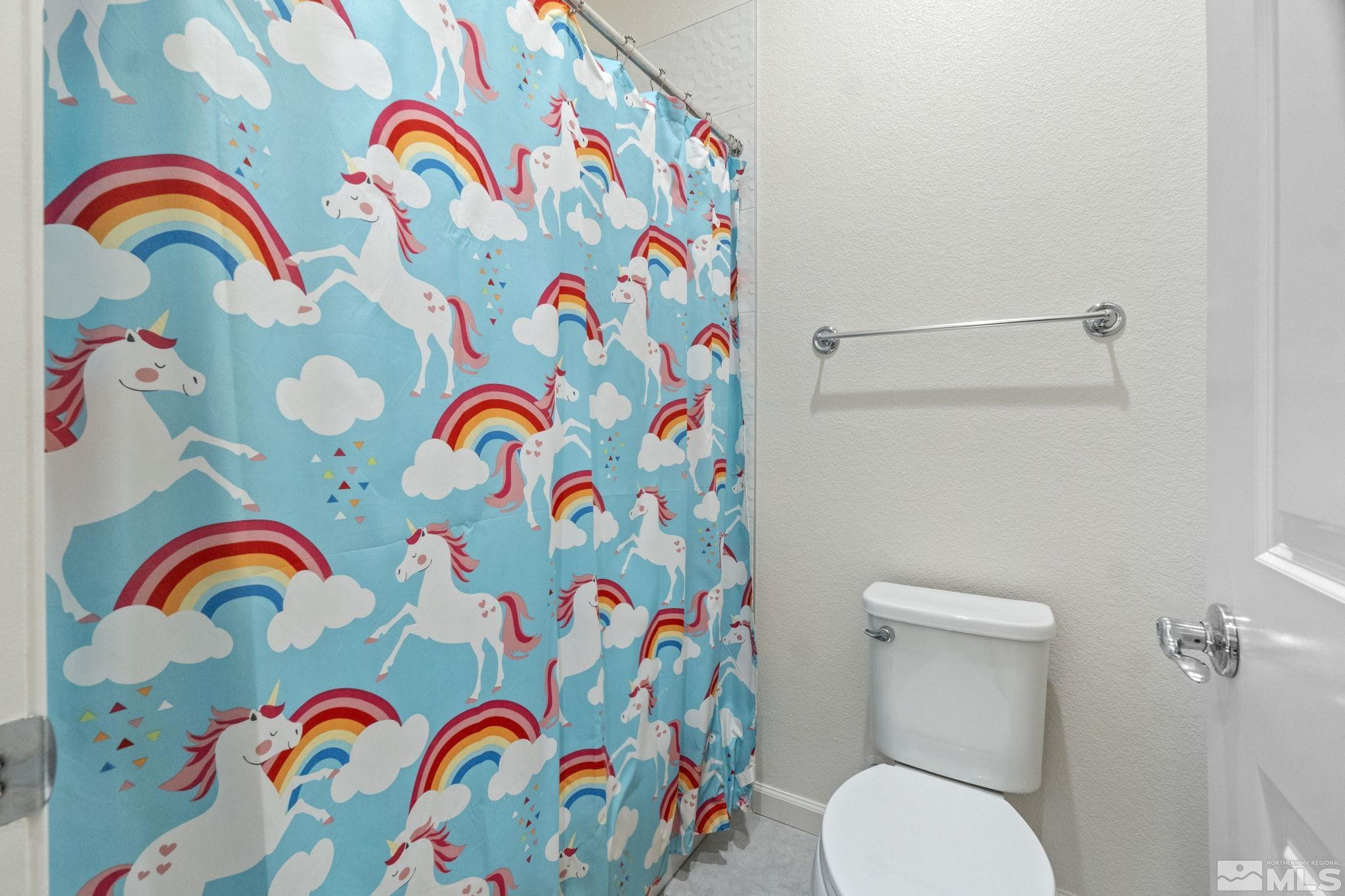 9401 Flying Horse Road Reno, NV 89521 - Photo 31 of 40 a bathroom with a toilet that has painting on the wall