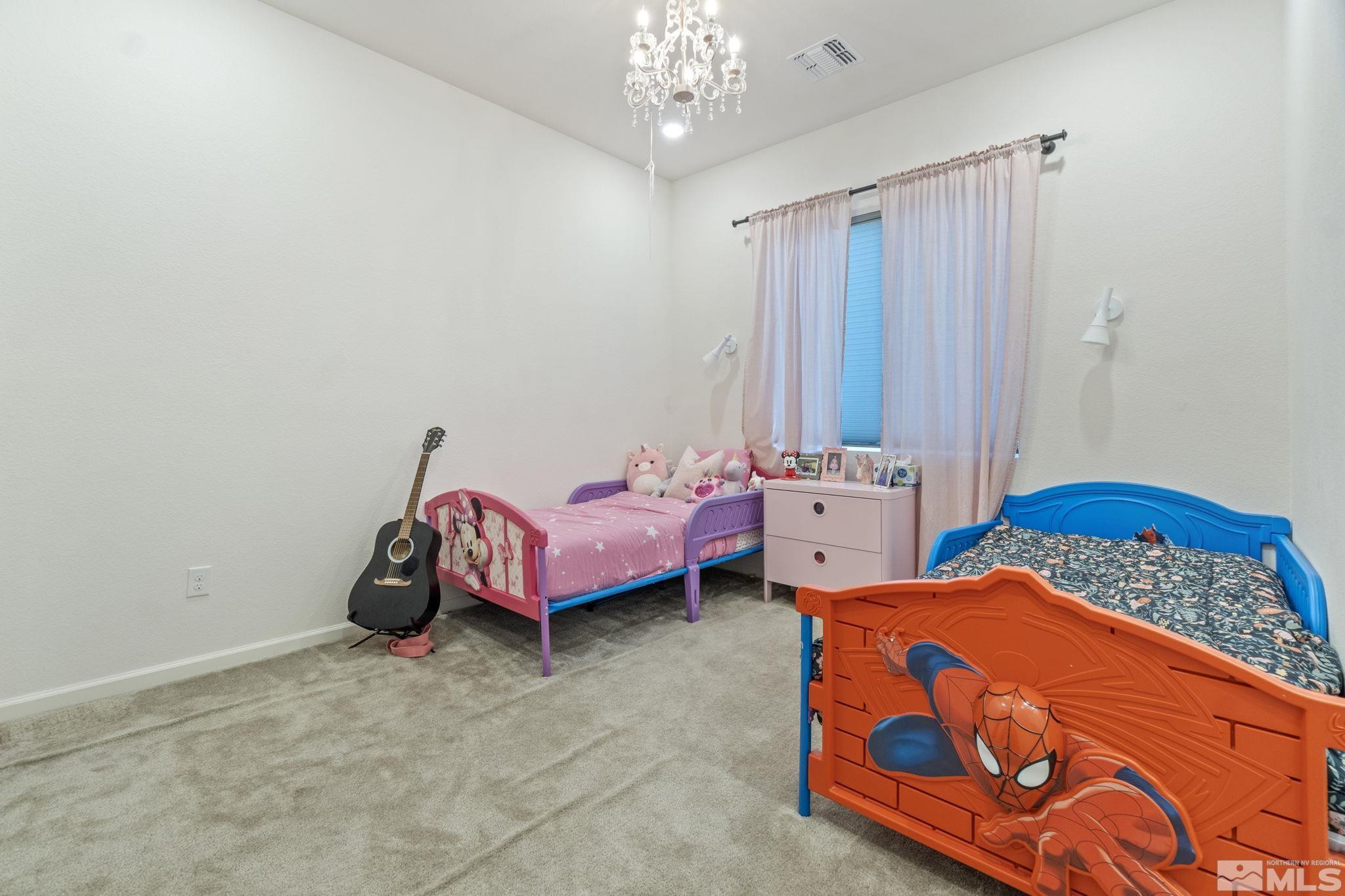 9401 Flying Horse Road Reno, NV 89521 - Photo 32 of 40 a bedroom with bed and a chandelier