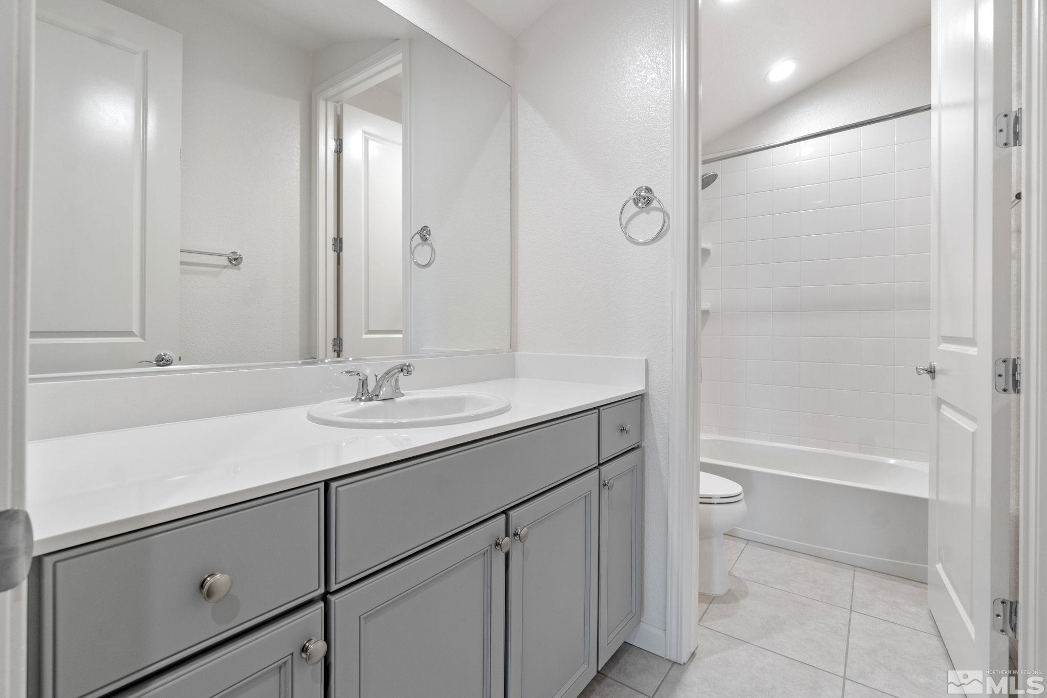 9401 Flying Horse Road Reno, NV 89521 - Photo 33 of 40 a bathroom with a sink a toilet and shower