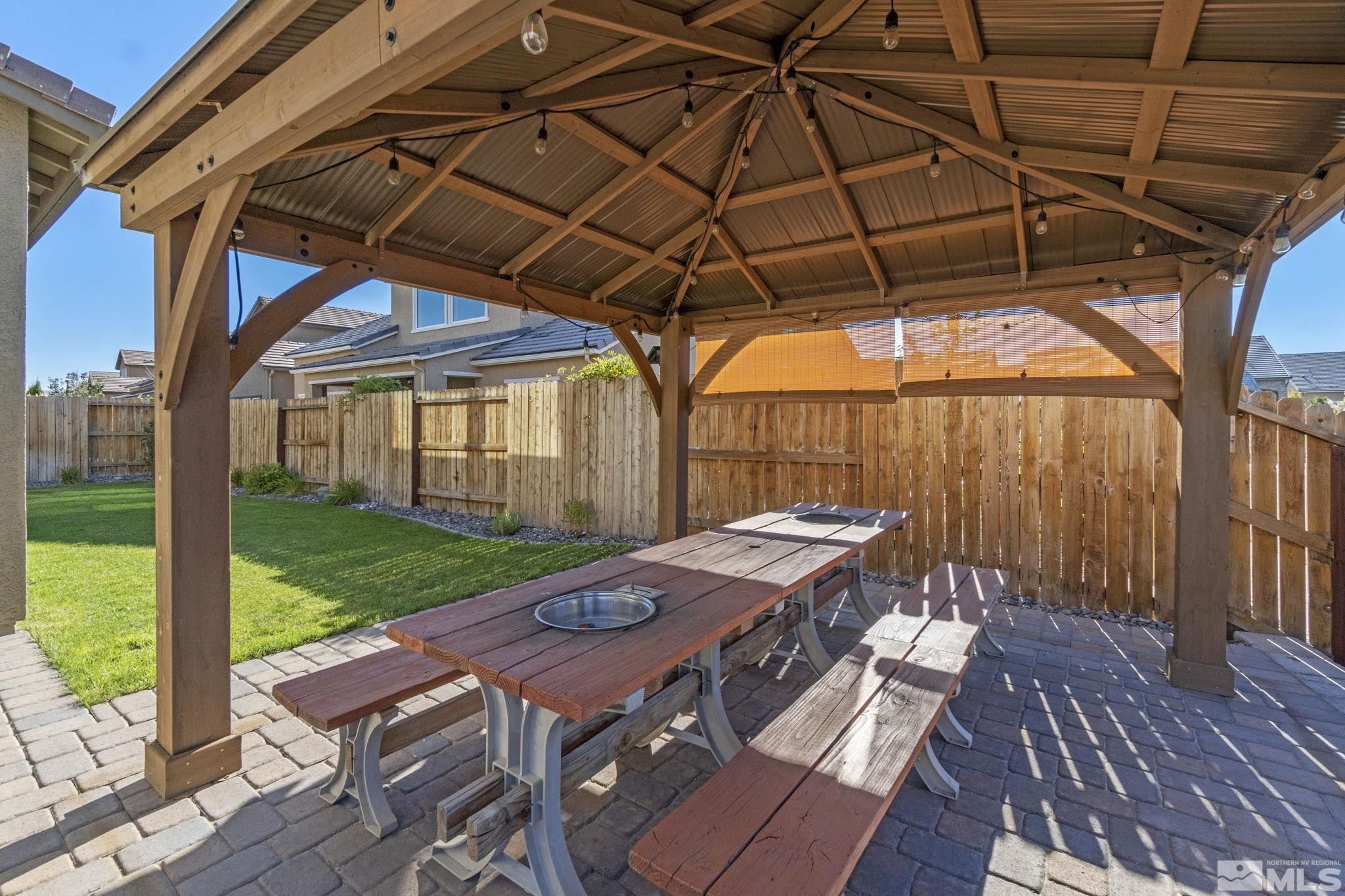 9401 Flying Horse Road Reno, NV 89521 - Photo 39 of 40 a view of a backyard with table and chairs under an umbrella with wooden floor