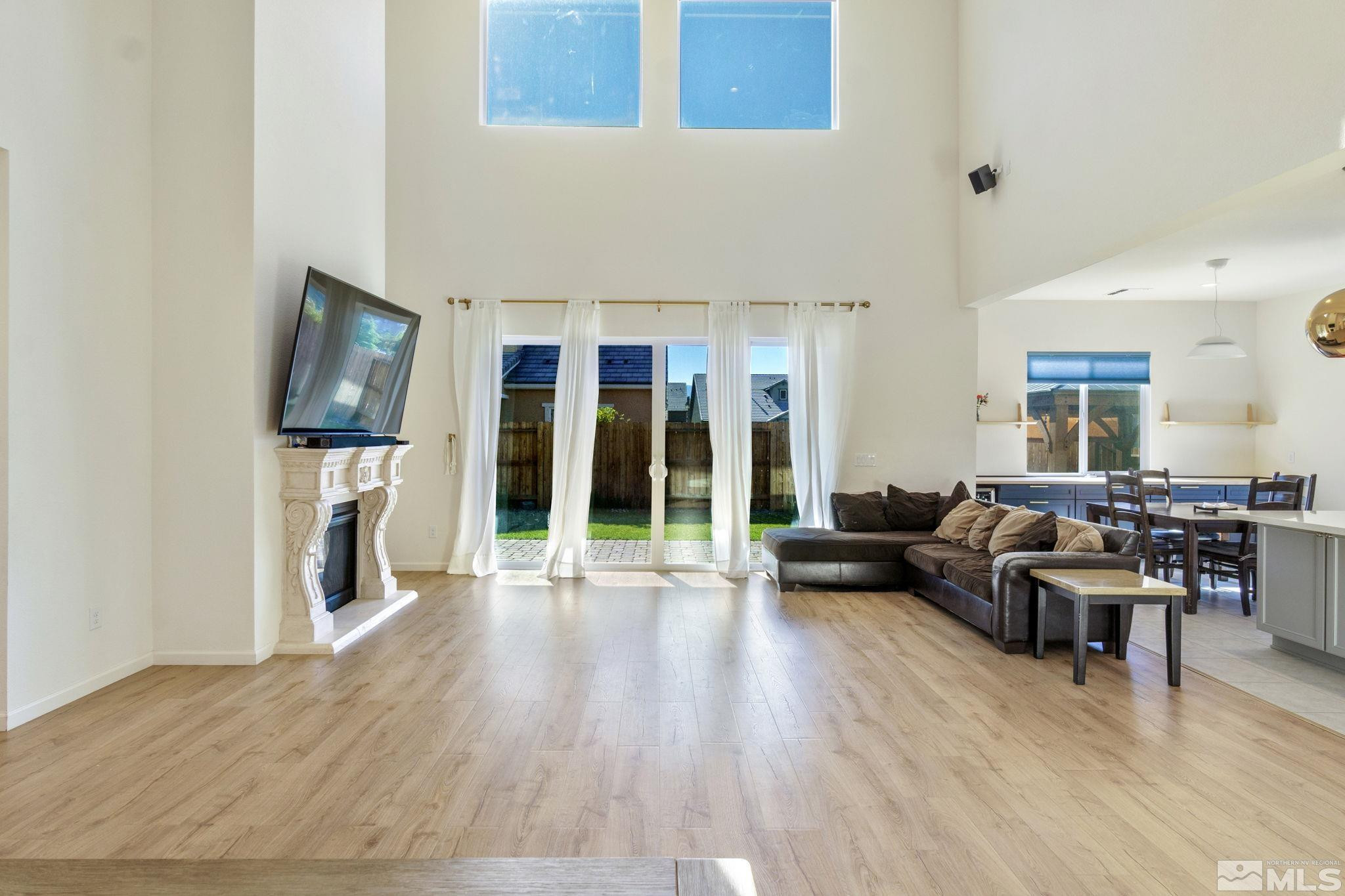 9401 Flying Horse Road Reno, NV 89521 - Photo 4 of 40 a living room with furniture flat screen tv and a fireplace