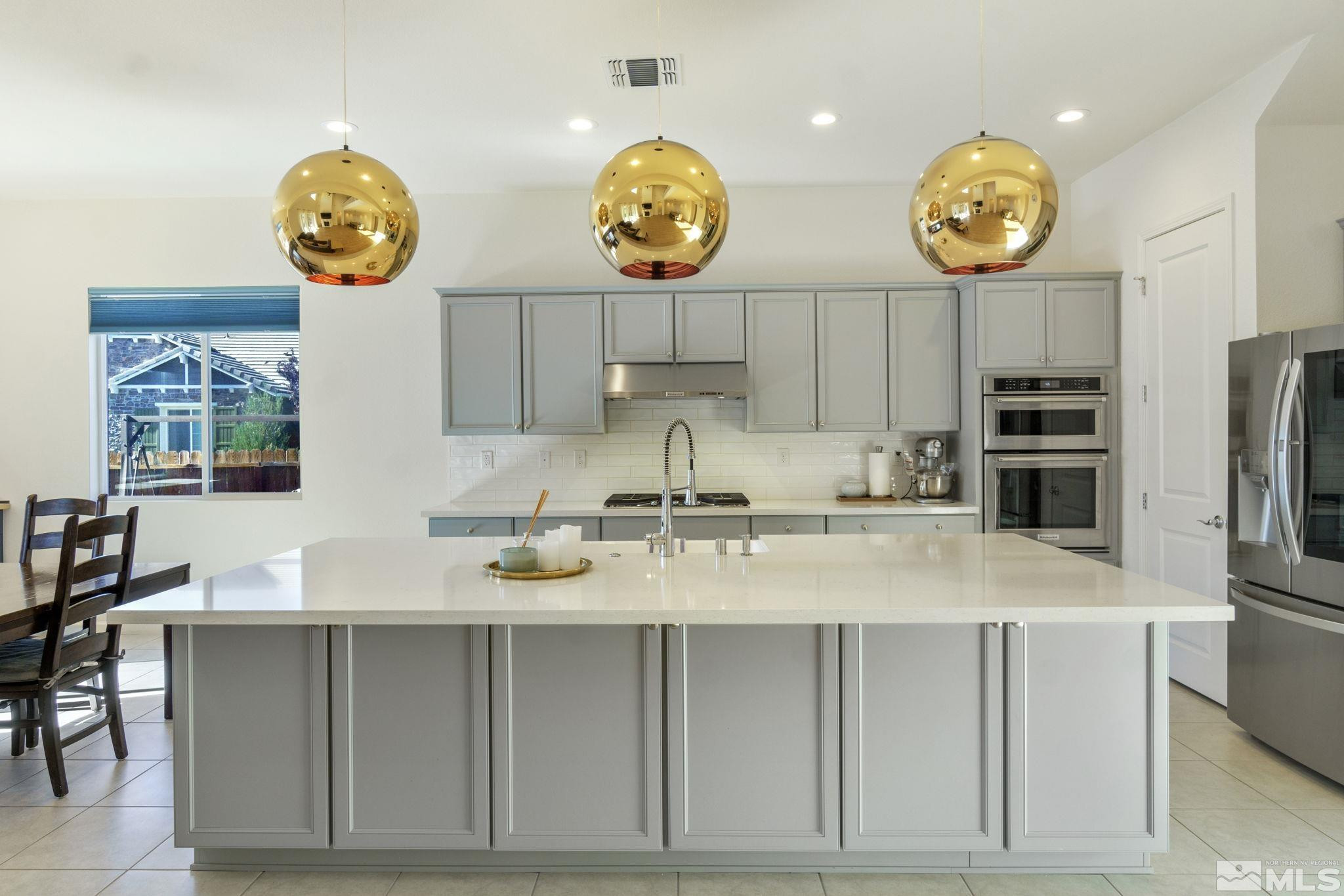 9401 Flying Horse Road Reno, NV 89521 - Photo 9 of 40 a kitchen with stainless steel appliances granite countertop a stove a sink and a refrigerator