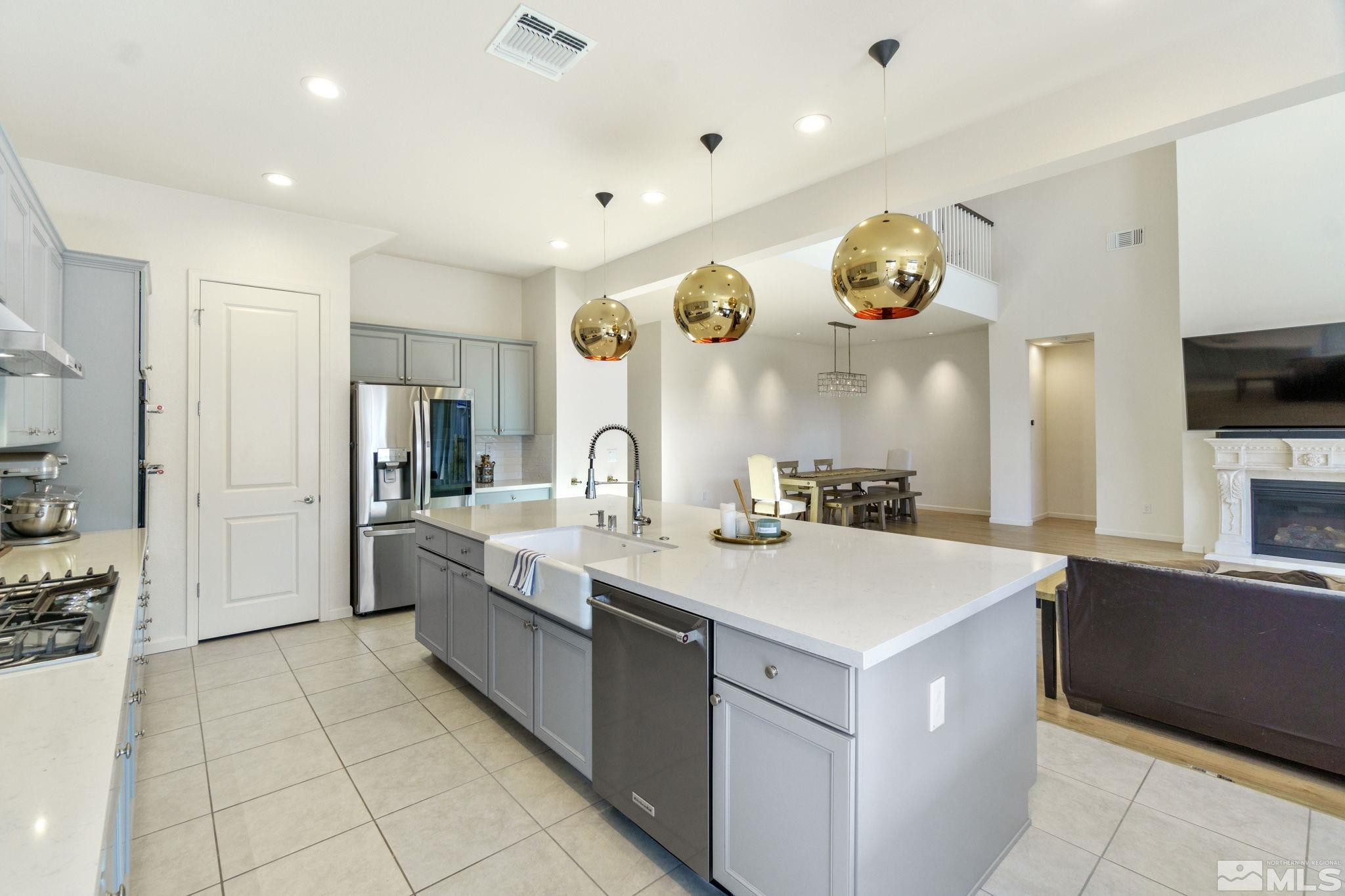 9401 Flying Horse Road Reno, NV 89521 - Photo 10 of 40 a large white kitchen with a large counter top cabinets and stainless steel appliances