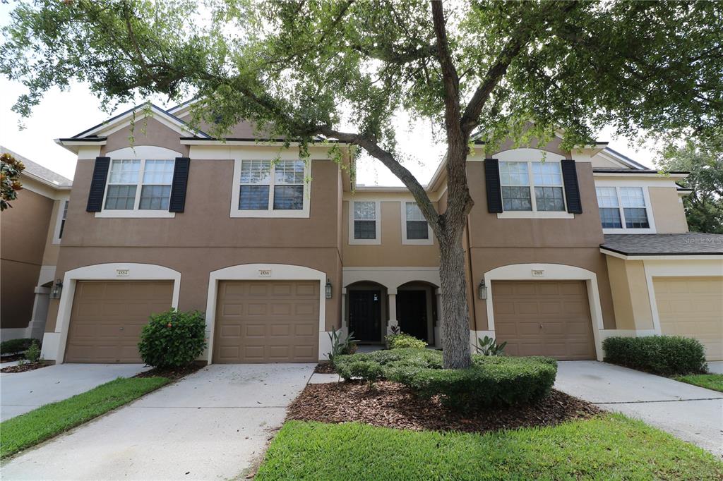 4866 Pond Ridge Drive Riverview, FL 33578 - Photo 1 of 38 a front view of a house with a garden and plants
