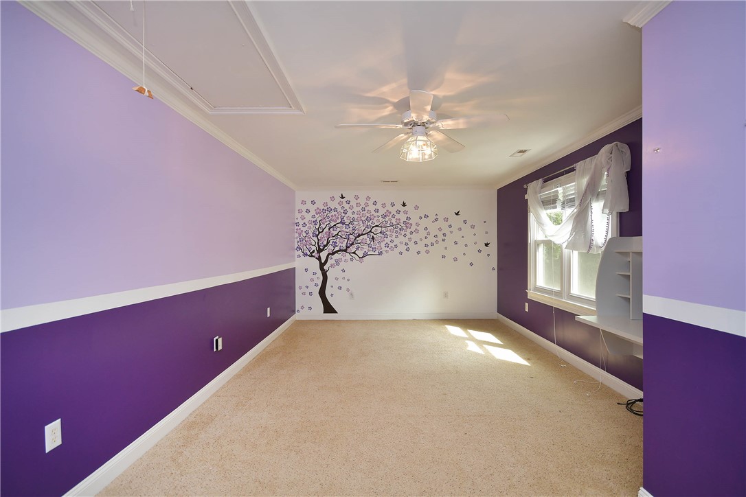 197 Deer Creek Road Easley, SC 29640 - Photo 25 of 50 A cheerful room with vibrant two-tone walls and a playful tree decal, offering an inviting atmosphere.