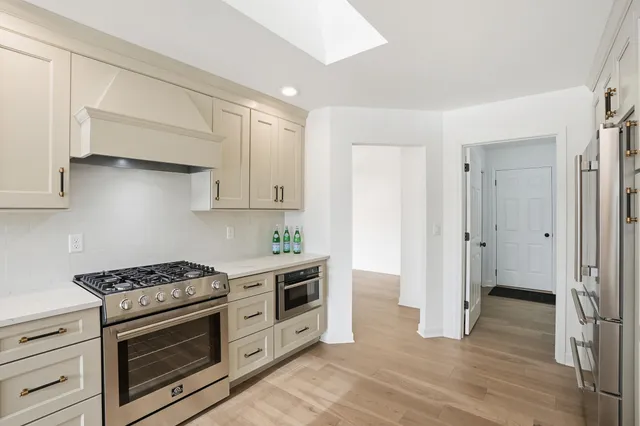 a kitchen with stainless steel appliances a stove and a refrigerator