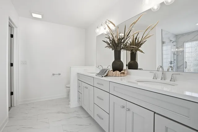 a bathroom with a double vanity sink and a mirror