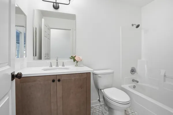 a bathroom with a granite countertop toilet a sink and a bathtub