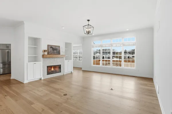 a view of an empty room with a fireplace and a window