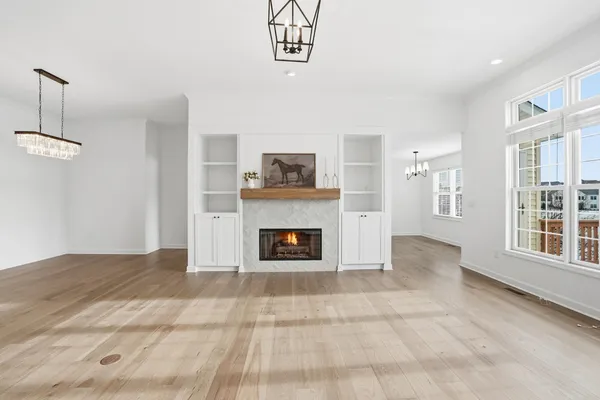 a view of a livingroom with a fireplace and window