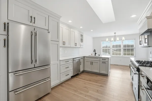 a kitchen with stainless steel appliances a refrigerator sink and cabinets