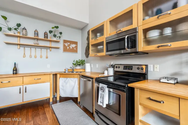 a kitchen with stainless steel appliances a stove a microwave and cabinets