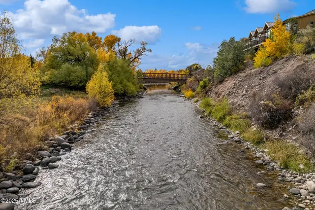 a view of a yard with wooden fence