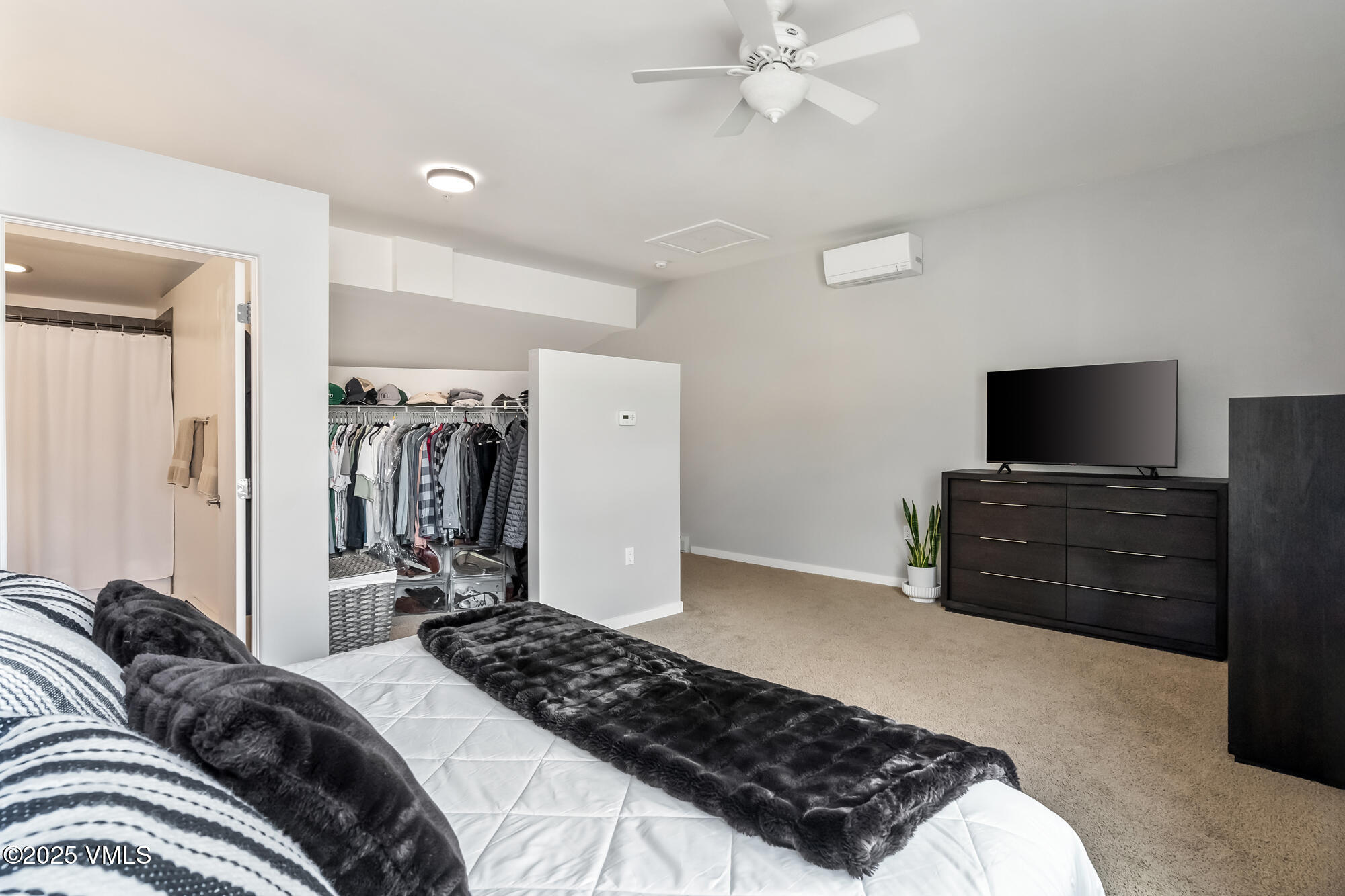 705 Nogal Road, Unit A8 Eagle, CO 81631 - Photo 22 of 33 a bedroom with a bed and a flat tv screen on a dresser