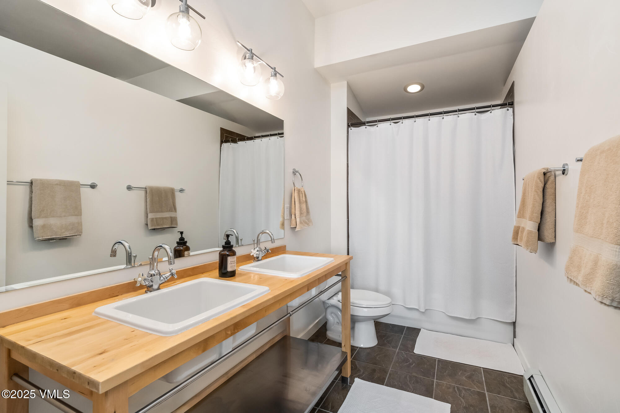705 Nogal Road, Unit A8 Eagle, CO 81631 - Photo 23 of 33 a bathroom with a sink a toilet a mirror and shower
