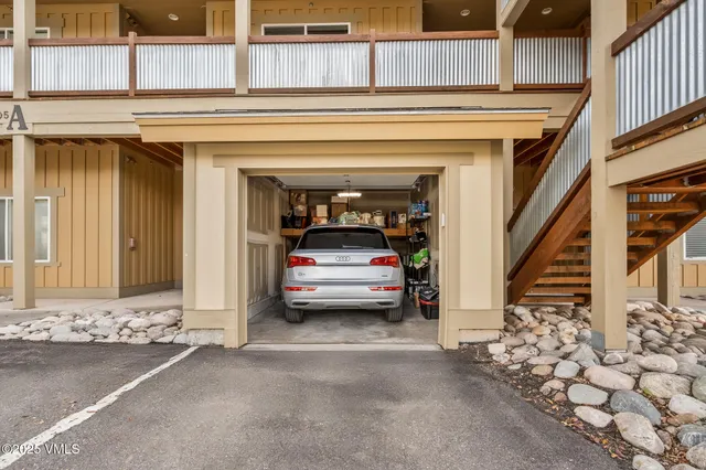 a view of a livingroom with entryway and stairs