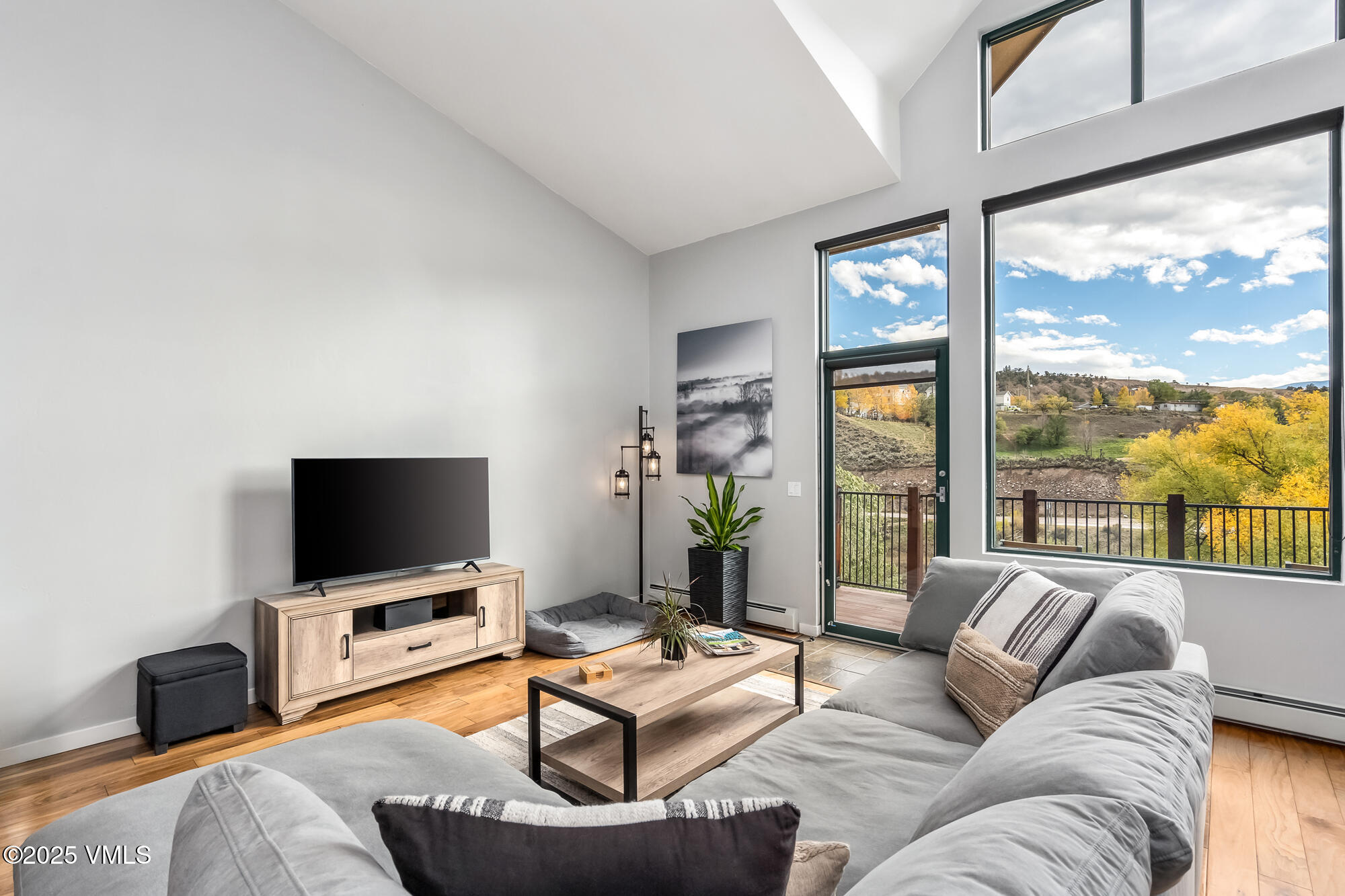 705 Nogal Road, Unit A8 Eagle, CO 81631 - Photo 5 of 33 a living room with furniture a flat screen tv and a large window