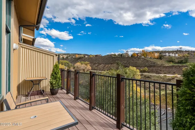 a view of a balcony with furniture and wooden floor