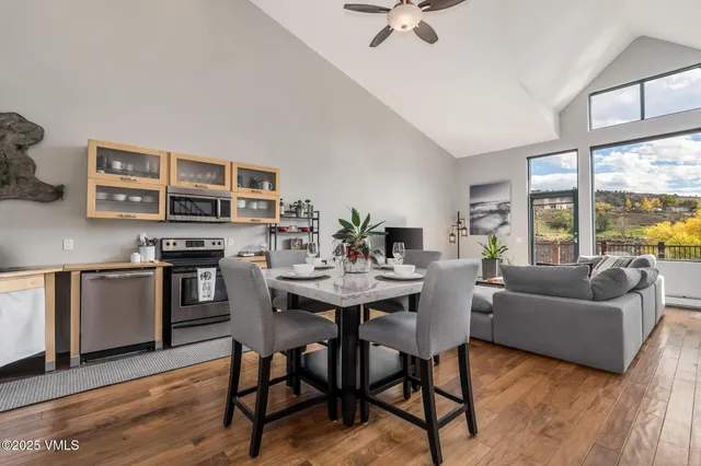 a living room with furniture and kitchen view