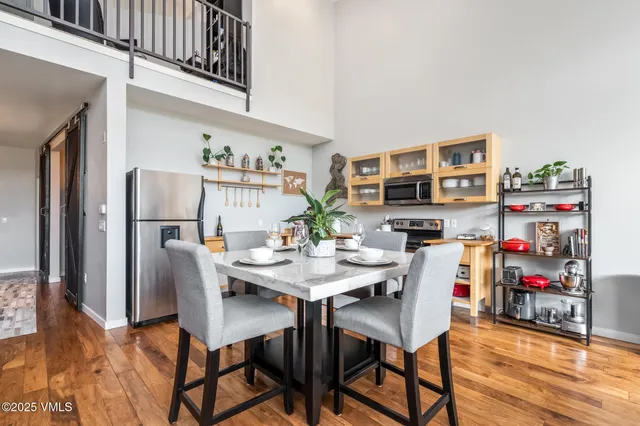a view of a dining room with furniture and a kitchen