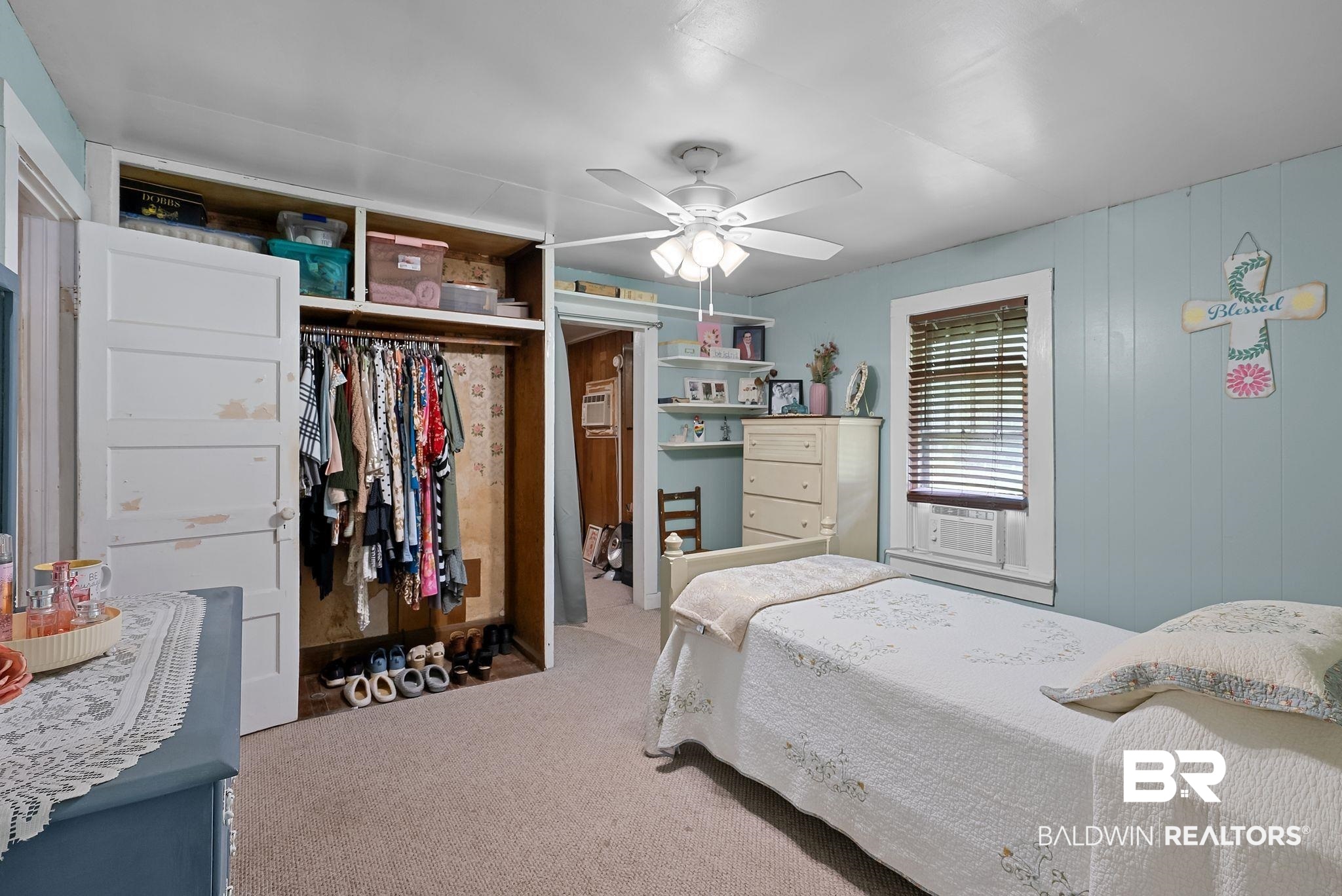 615 West Section Avenue Foley, AL 36535 - Photo 15 of 40 Carpeted interior space featuring a built-in open closet with shelving, a window with horizontal blinds, and a ceiling fan with integrated lighting