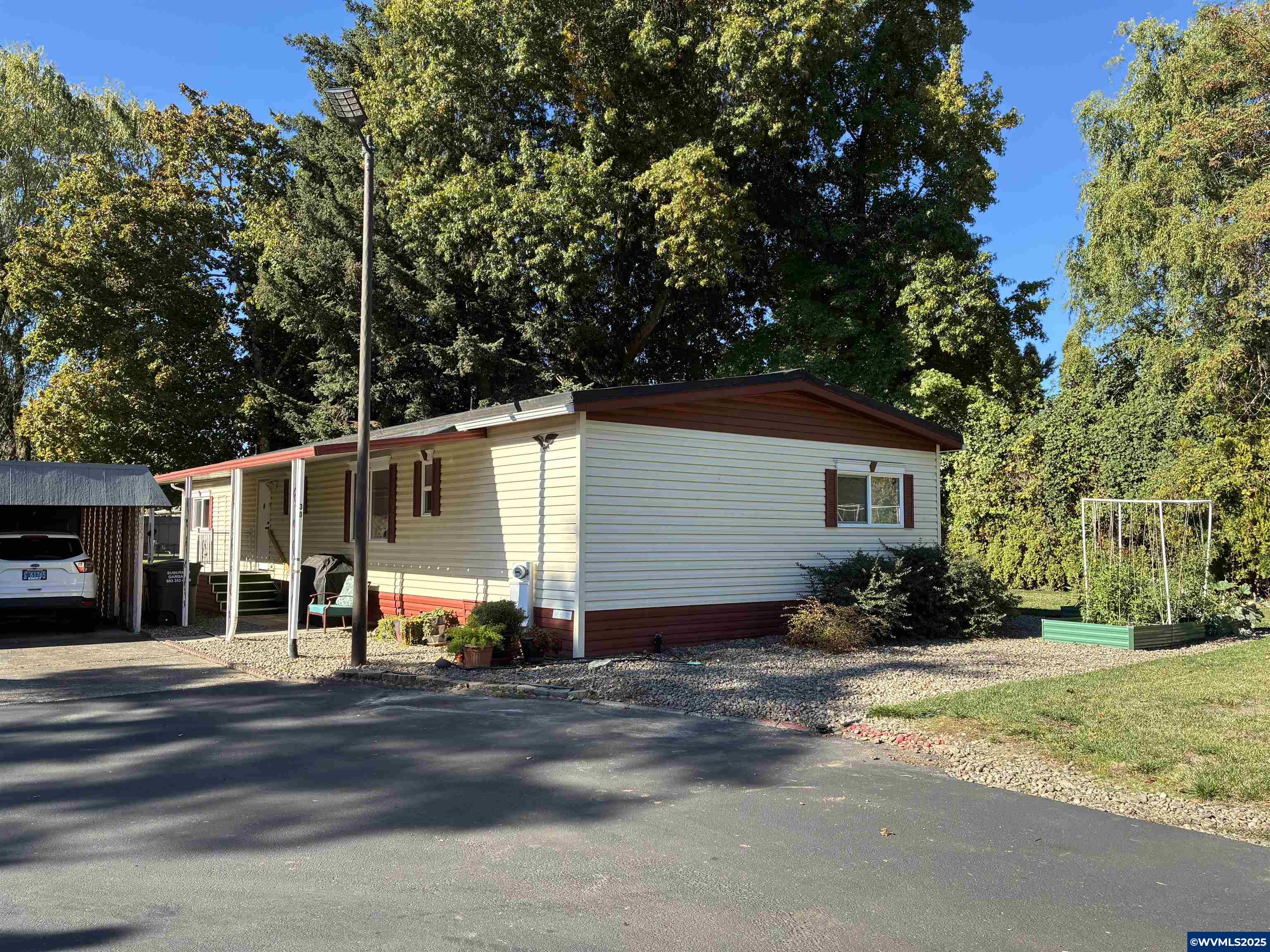 4915 Swegle Road Northeast, Unit 30 Salem, OR 97301 - Photo 28 of 31 a view of a white house with a large tree