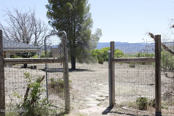 a view of a house with a yard and mountain