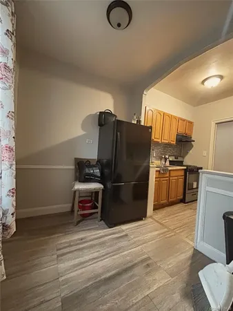 a kitchen with stainless steel appliances a refrigerator and a stove top oven