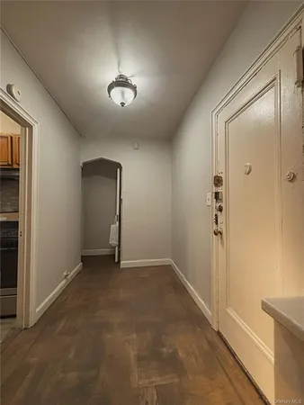 an empty room with closet and windows