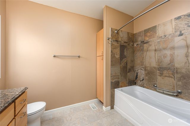 a bathroom with a shower and a toilet