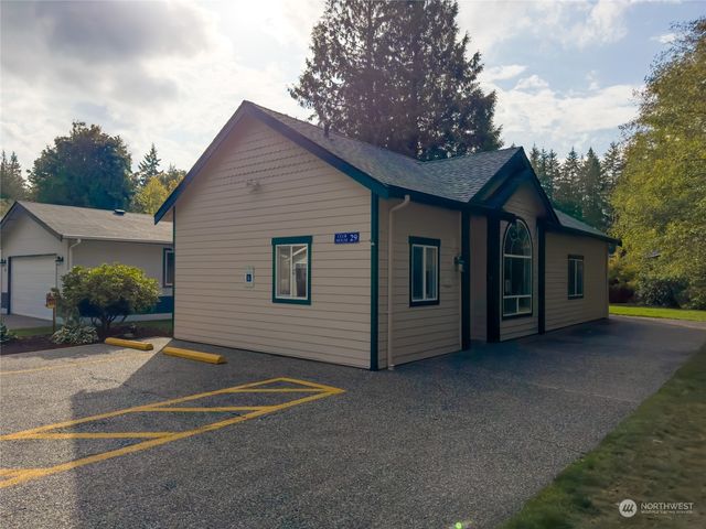 a view of a house with a backyard and garage