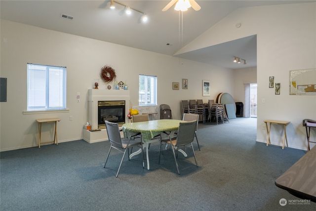 a dining room with furniture a fireplace and wooden floor