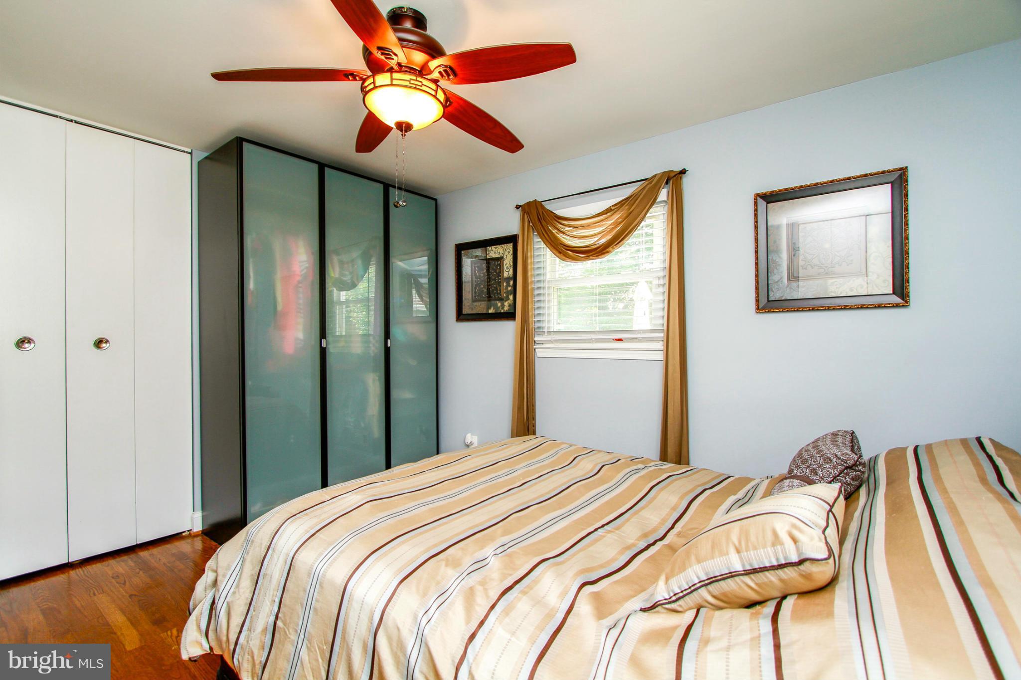 6202 Collinsway Road Baltimore, MD 21228 - Photo 13 of 30 a bedroom with a bed and a chandelier