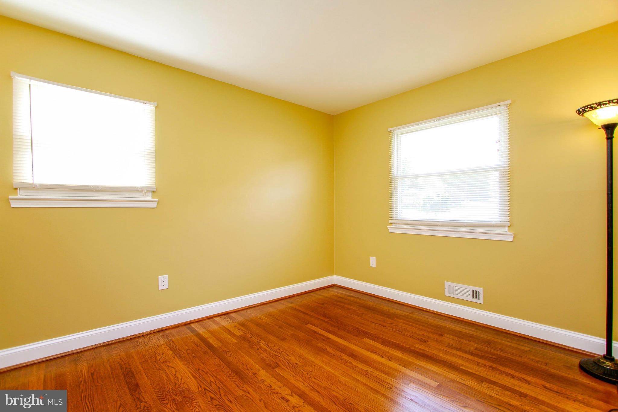 6202 Collinsway Road Baltimore, MD 21228 - Photo 14 of 30 a view of an empty room with wooden floor and a window