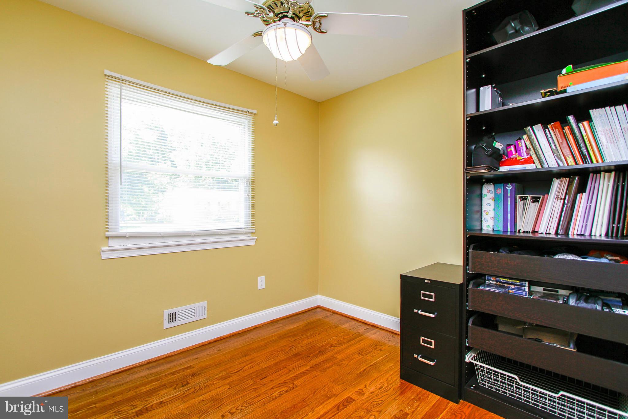 6202 Collinsway Road Baltimore, MD 21228 - Photo 15 of 30 a view of room with lounge chair and book shelf