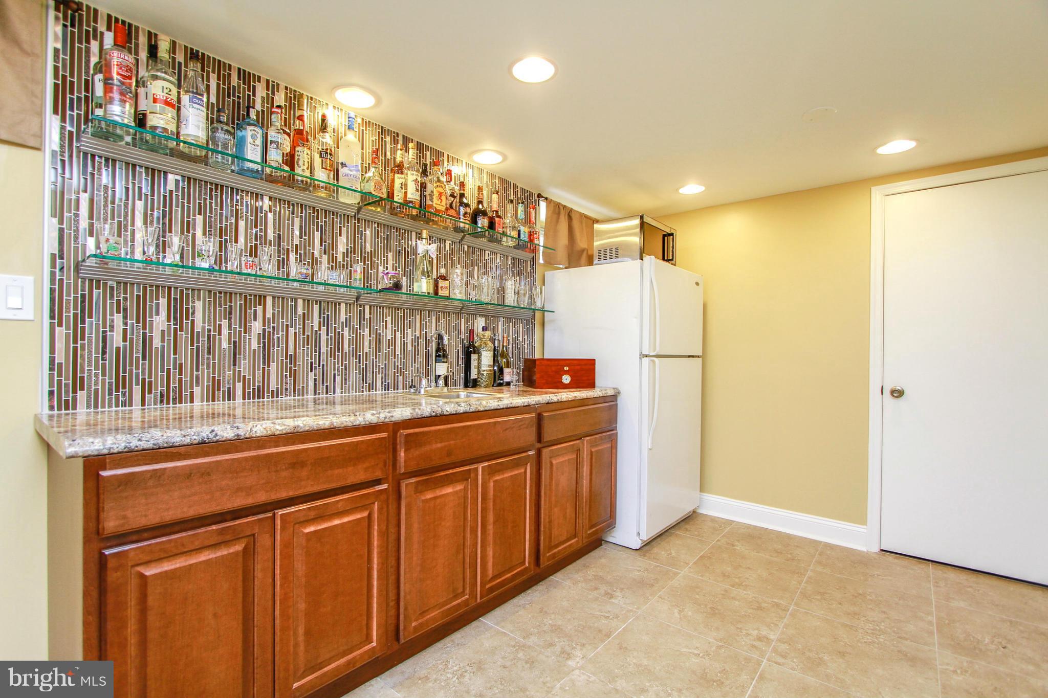 6202 Collinsway Road Baltimore, MD 21228 - Photo 21 of 30 a kitchen with granite countertop a refrigerator and a sink