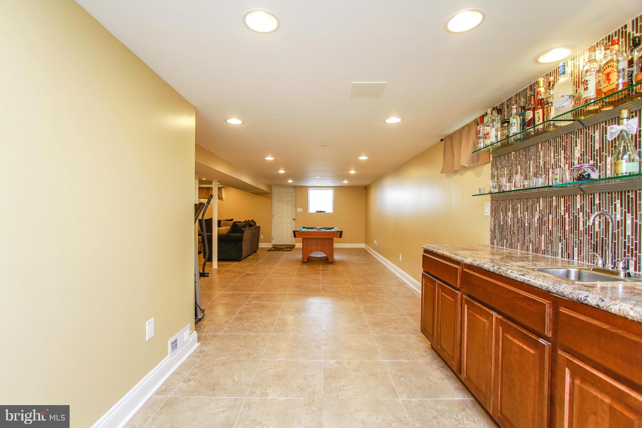 6202 Collinsway Road Baltimore, MD 21228 - Photo 22 of 30 a view of a kitchen with a sink and cabinets