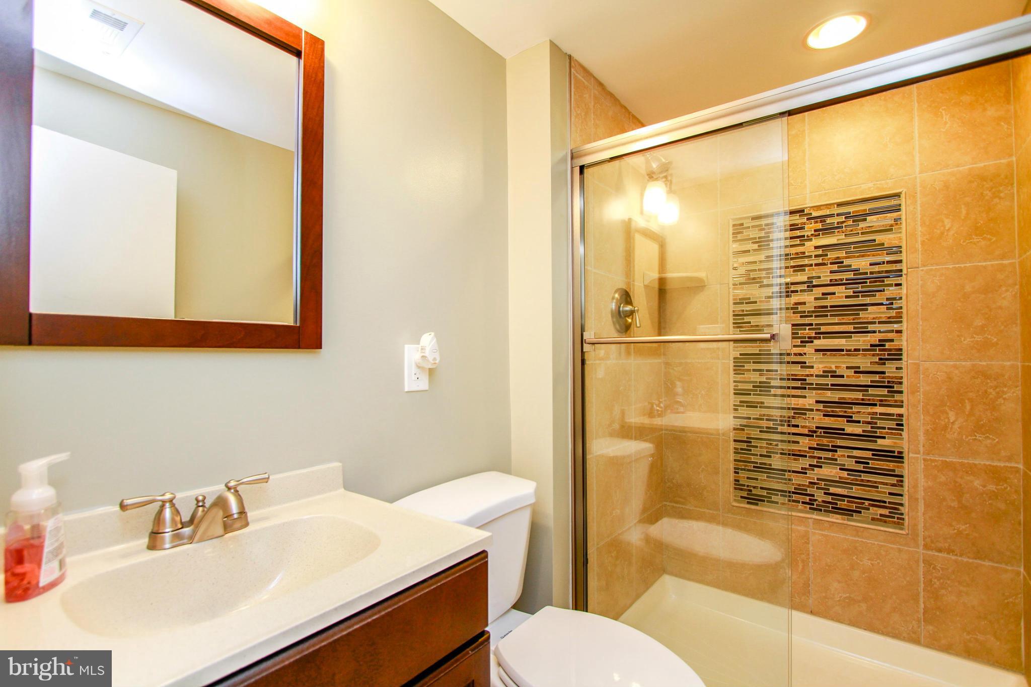 6202 Collinsway Road Baltimore, MD 21228 - Photo 24 of 30 a bathroom with a sink toilet and shower